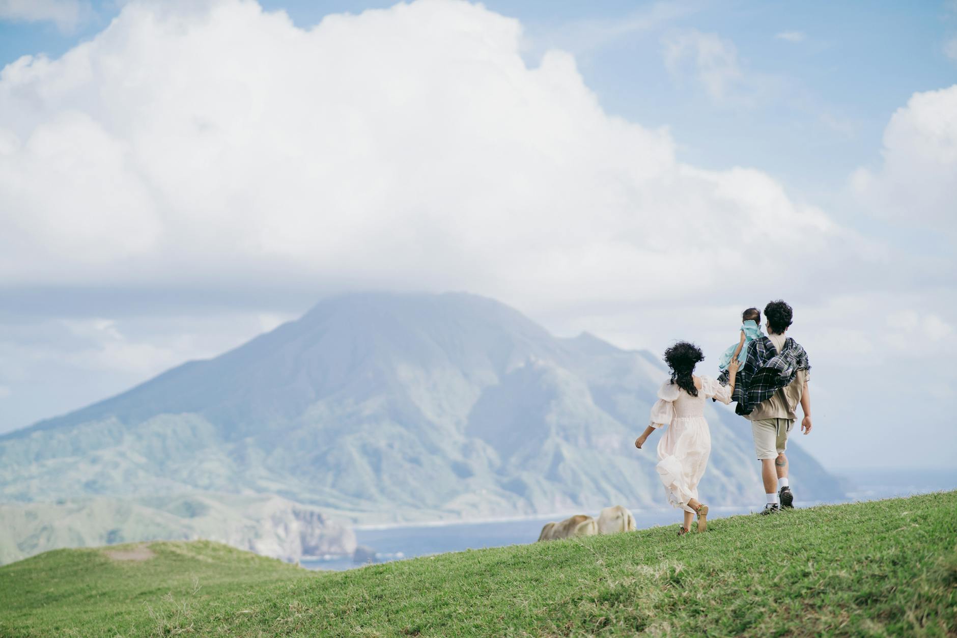 Rodzina spaceruje po zielonej dolinie w górskim krajobrazie